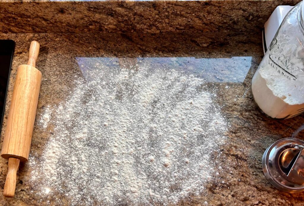 Counter covered in a thin layer of flour, prepared for rolling pie crust out on. Desert Recipe