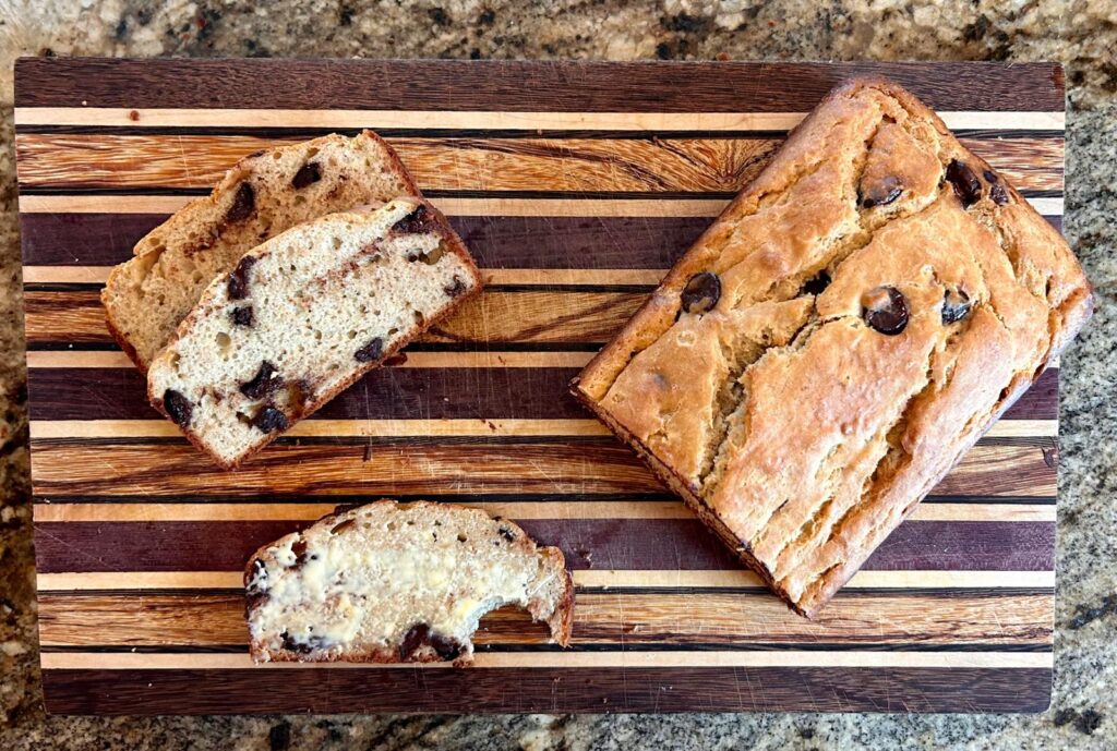 Compleated protein banana bread sliced on a cutting board and ready to be served.